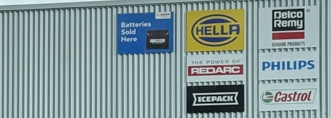 Supplier boards on the workshop wall: Bosch batteries, HELLA, REDARC, ICEPACK, Delco Remy, Philips and Castrol